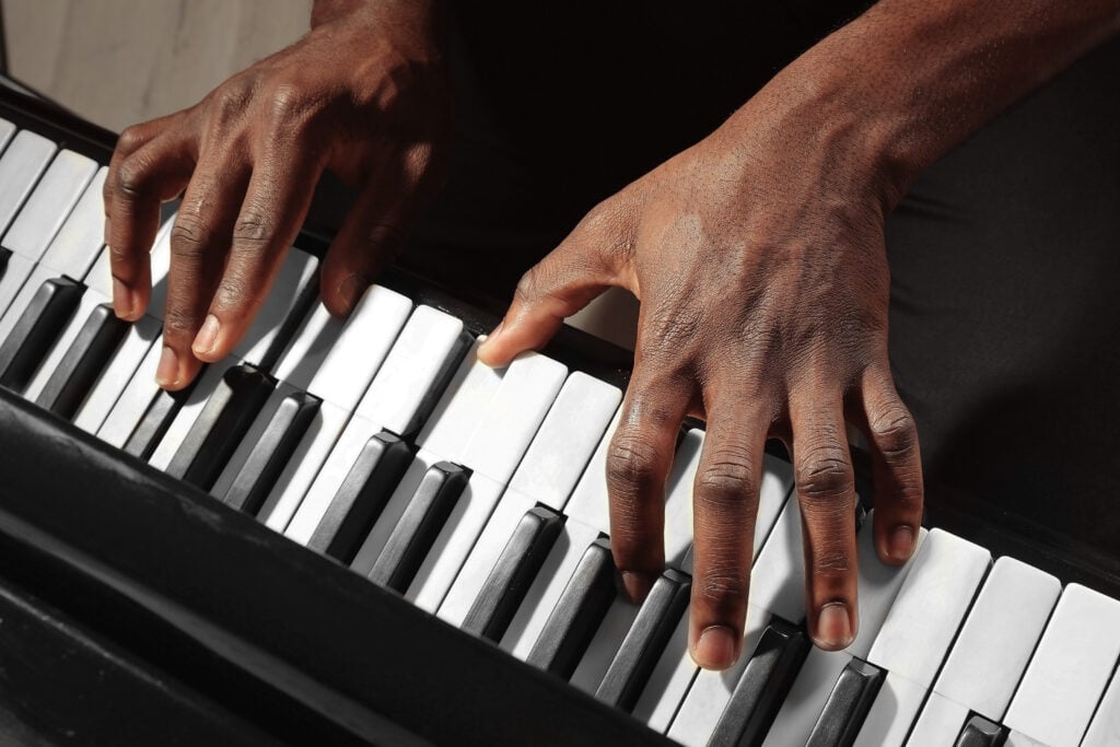 African American man hands playing piano